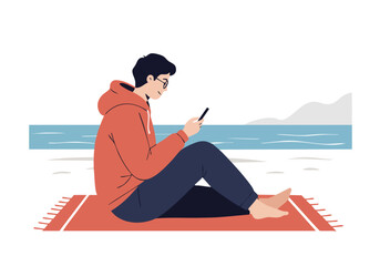 A young man with dark hair sits on a beach blanket, looking at his phone. Relaxed, casual style, enjoying the ocean view. Perfect for travel, leisure, or digital lifestyle concepts.