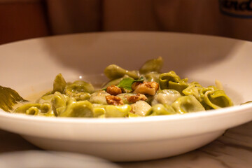 Closeup image of a bowl of pasta elegantly on a table