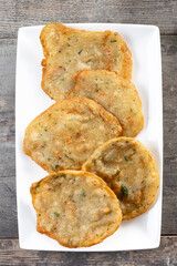 Tortillitas de camarones on wooden table. Typical Andalucia food.