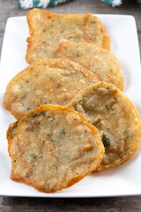 Tortillitas de camarones on wooden table. Typical Andalucia food.