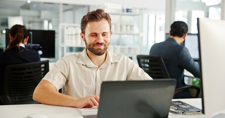 Happy man, laptop or typing in hospital for research, project management or scientific study. Medical engineer, tech or smile in coworking space for healthcare review with pharmaceutical development