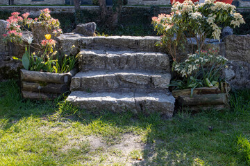 Four Granite steps up to river defence in Lostwithiel with flowers