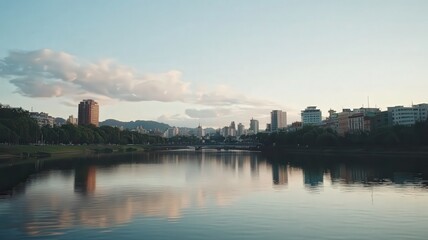 Fototapeta premium Urban Skyline Reflecting in Calm Lake Under Blue Sky Featuring Modern Architecture and Lush Green Trees Along the Waterfront in Daytime