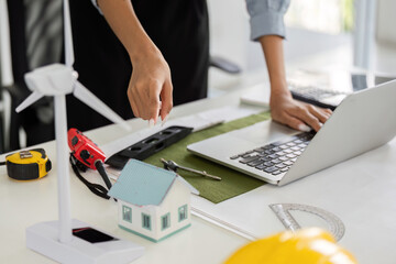 Sustainable Solutions and Technology. A designer integrating digital tools in sustainable project designs.