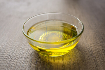 Cooking oil in a glass  on wooden background