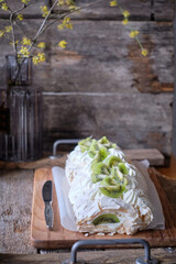 meringue roll with kiwi. Spring, blossoming branch, juicy.