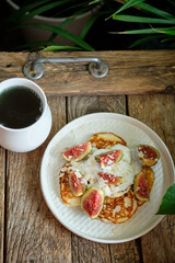 pancakes with sour cream, figs and coconut flakes
