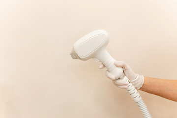 Laser device for removing unwanted hair in the hand of nurse. Laser hair removal, cosmetic body...