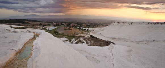 Panoramic landscape of Pamukkale travertine terraces at sunset, Turkey