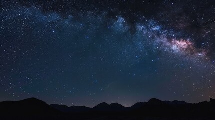 Fototapeta premium Starlit night over mountains with vibrant milky way in the clear sky