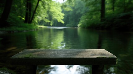 Fototapeta premium Rustic wooden bench by a tranquil river in a lush forest
