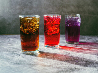A lot of Soft drinks in colorful and flavorful glasses on the table,Glasses with sweet drinks with ice cubesv