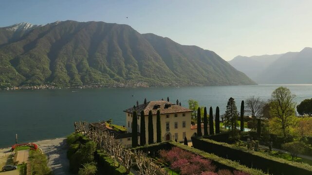 aerial drone footage of famous historic villa Balbiano Como Lake Italy. Surrounded by mountains, luxury destination wedding venue 