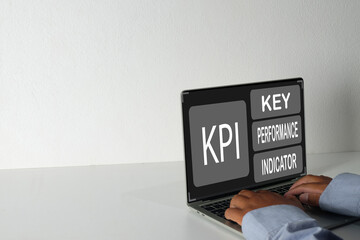 Businessman working on laptop showing KPI dashboard on screen laptop idea for key performance indicator analysis for business strategy,marketing analysis, and performance management.