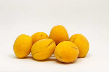 Bunch of yellow peaches are piled on top of each other
