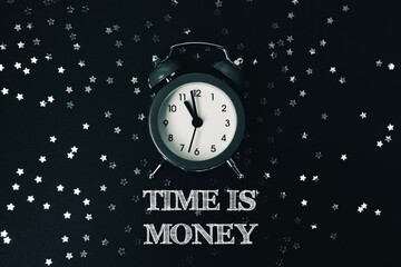 Black and white photo of a clock with the words "Time is money" written below