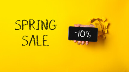 Person holding a cell phone with the words Spring Sale written on it