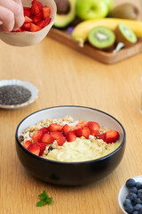 Healthy breakfast bowl with yogurt, strawberries, and granola topping