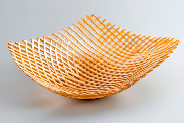 Obraz premium beautifully crafted woven basket with unique geometric design, showcasing intricate patterns and warm wooden color