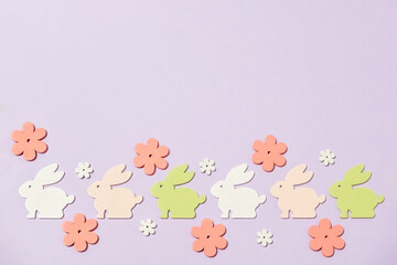 Row of rabbits and flowers on a purple background