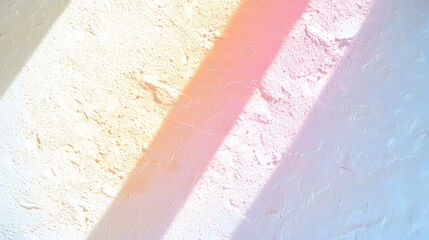 Sunlight casts pastel shadows on a textured white wall creating a beautiful abstract background.