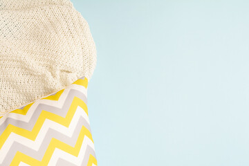 Pillow with zigzag pattern with textile plaid on blue background