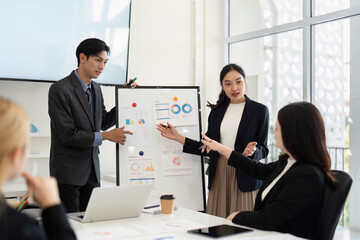 Business Discussion and Collaboration. A team engaged in a strategic meeting, presenting data and discussing project insights.
