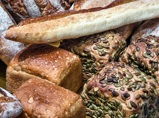 Freshly baked bread assortment on display at a bakery during morning hours
