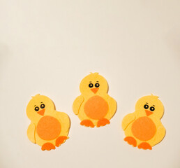 Three yellow chicks sitting on a white background