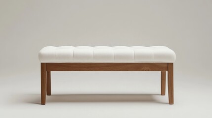 White tufted ottoman bench with wooden frame on a white background in a studio setting showing the bench