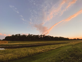 Beautiful sunset over a field with trees and a river