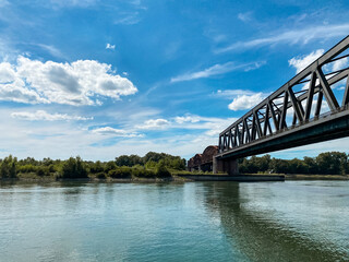 Bridge spans a river with a blue sky in the background