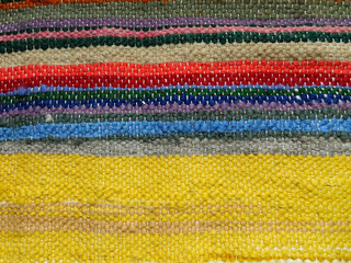 Obraz premium Element of a colorful natural sheep wool blanket. Traditional hand weaving products 