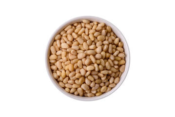 Peeled pine nuts in a bowl on a white background
