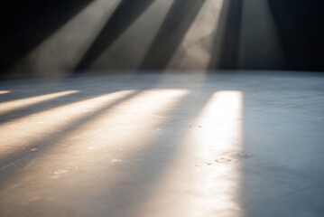 close-up of the stage floor with visible scuff marks and light beams crossing.