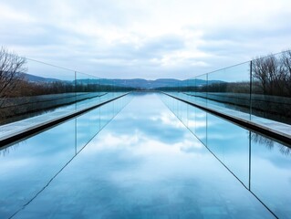 Glass bridge mirroring in calm river and futuristic minimalism with soft lighting and negative space below