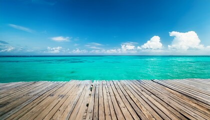 Fototapeta premium Wooden jetty on the turquoise sea with sunny blue sky background