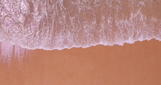 Beautiful sea summer landscape, Waves sea water surface High quality video Bird's eye view, Drone top view waves crashing on sand beach,Nature ocean sea beach background