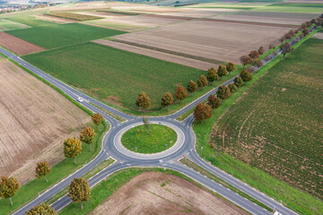 A bird's-eye view of a roundabout in Rheinhessen surrounded by fields and meadows