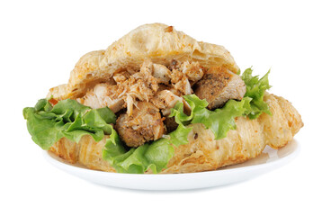 Croissant with grilled chicken meat on white plate isolated on white background. Croissant sandwich.