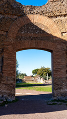Hadrian Villa archaeological site viewed through ancient roman brick gate 