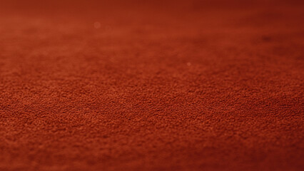 A warm red suede serves as the backdrop