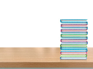 Stack of books on wooden table PNG transparent.