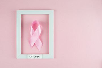 World Breast Cancer Day. Pink ribbon white frame on pink background,