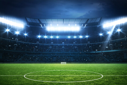 Football stadium full of fans, grass pitch and with spotlights on. Sport building - Powered by Adobe