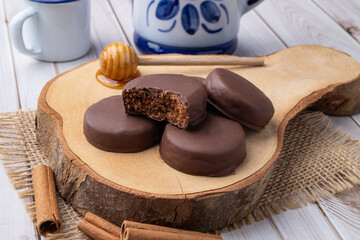 Brazilian Pao de Mel or chocolate covered honey cookies over a wooden table