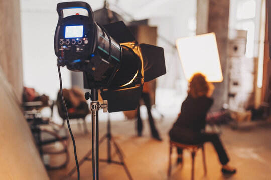 Captivating artistry unfolds in a photography studio filled with warm light and creative energy during a session, focused on studio flash.