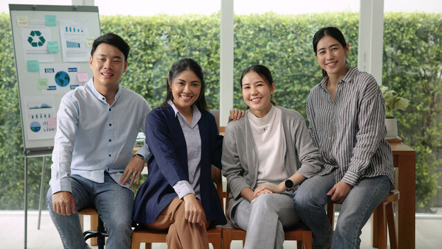 Young adult asia people diverse team group Gen Z go green workforce ESG office happy relax smile looking at camera. Future growth asian man woman staff meeting working on Net Zero waste SDGs project