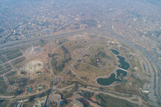 Aerial view of Minar-e-Pakistan surrounded by beautiful greenery and modern architecture in Lahore, Punjab, Pakistan.