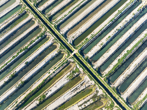 Aerial view of salt works with beautiful patterns and tranquil water, Isla Cristina, Huelva, Spain.